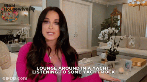 Woman In Pink Jacket Says Lounge Around In A Yacht Listening To Some Yacht Rock GIF