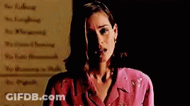Woman In Pink Jacket Standing In Front Of Rules GIF