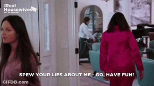 Woman In Pink Jacket Walking Hallway Saying Spew Your Lies About Me GIF
