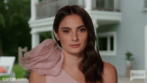 Woman In Pink One Shoulder Dress Looking At Camera GIF