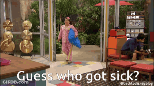 Woman In Pink Pajamas Holding Blue Pillow Man Behind GIF