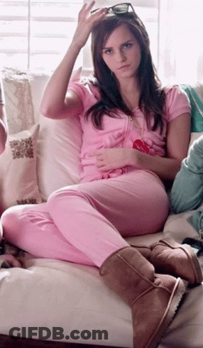 Woman In Pink Pajamas On Couch With Lollipop GIF