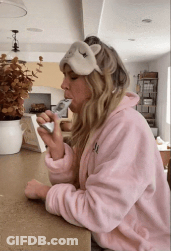 Woman In Pink Robe With Sleep Mask GIF
