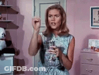 Woman In Pink Room Holding Wine GIF