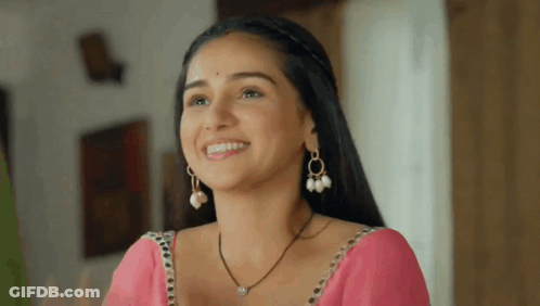 Woman In Pink Saree And Pearl Earrings Smiling GIF