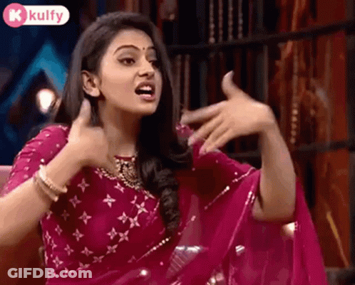 Woman In Pink Saree Making Funny Face Sitting In Chair GIF
