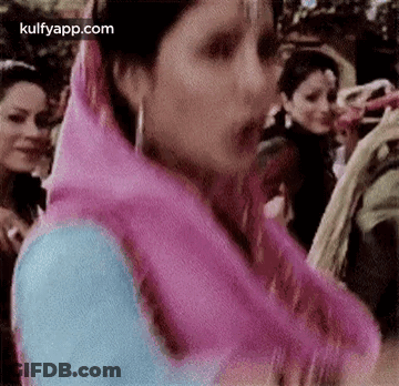 Woman In Pink Scarf Standing Before Crowd GIF