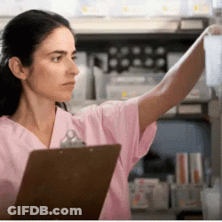 Woman In Pink Scrubs Reaching For Bottle GIF