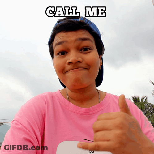 Woman In Pink Shirt And Blue Hat Thumbs Up Saying Call Me GIF