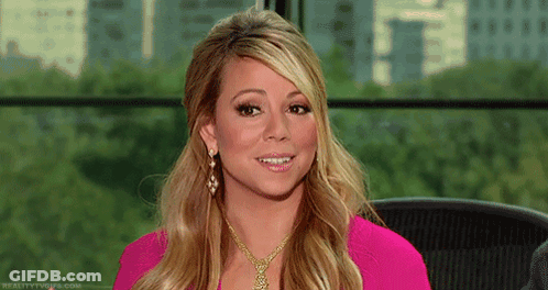 Woman In Pink Shirt And Gold Necklace Smiling GIF