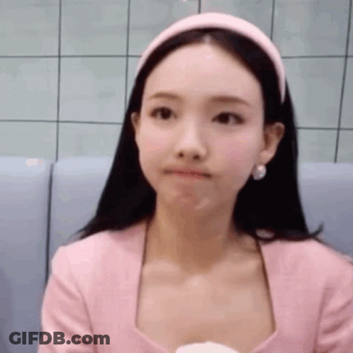 Woman In Pink Shirt And Headband Sitting On Couch GIF