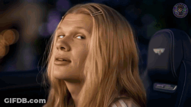 Woman In Pink Shirt And Purple Jacket Smiling GIF