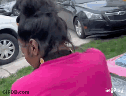 Woman In Pink Shirt By Black Car GIF