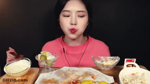 Woman In Pink Shirt Eating Food With Spoon GIF