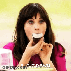 Woman In Pink Shirt Eating Frosted Cupcake GIF