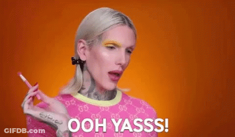 Woman In Pink Shirt Holding Pencil Saying Ooh Yasss GIF