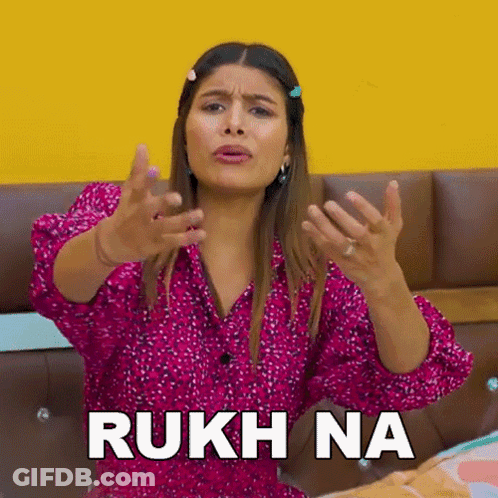Woman In Pink Shirt Making Funny Face On Couch GIF