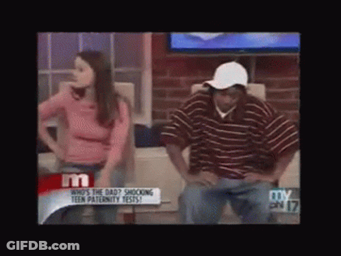 Woman In Pink Shirt Next To Man In Stripes GIF