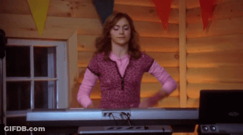Woman In Pink Shirt Playing Piano GIF