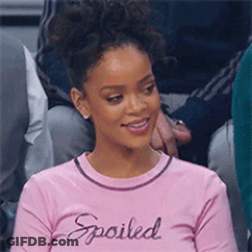 Woman In Pink Shirt Saying Spoiled Sitting In Crowd GIF