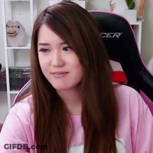 Woman In Pink Shirt Sitting In Chair With Cer GIF
