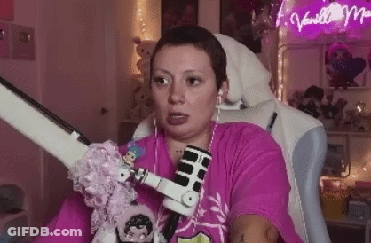 Woman In Pink Shirt Sitting With Microphone And Headphones GIF