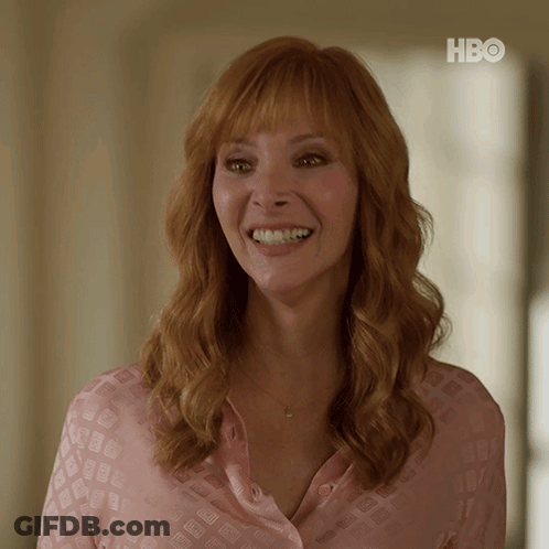 Woman In Pink Shirt Smiling At HBO Sign GIF