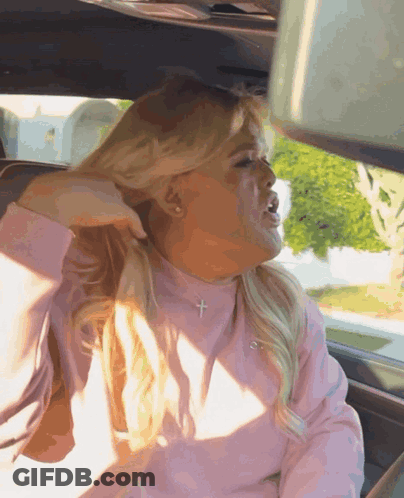 Woman In Pink Shirt With Cross Necklace GIF