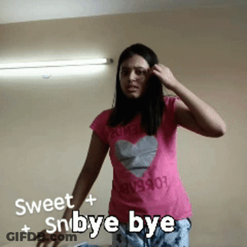 Woman In Pink Shirt With Heart Saying Sweet + Snbye Bye GIF