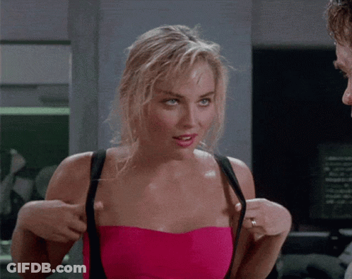 Woman In Pink Strapless Top Adjusting Bra Straps GIF