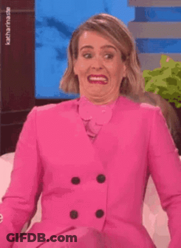 Woman In Pink Suit Making Funny Face GIF