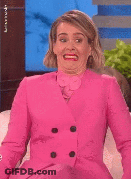 Woman In Pink Suit Making Funny Face GIF