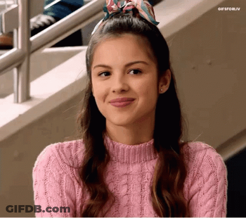 Woman In Pink Sweater And Scarf Smiling GIF