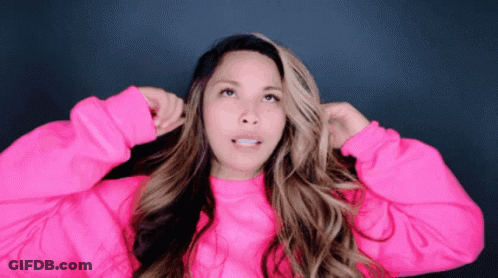 Woman In Pink Sweater Holding Hair Up GIF