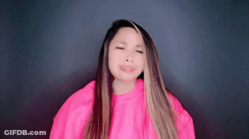 Woman In Pink Sweater Making Funny Face GIF