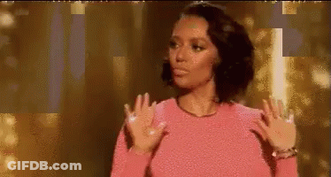 Woman In Pink Sweater Making Funny Face Gold Background GIF