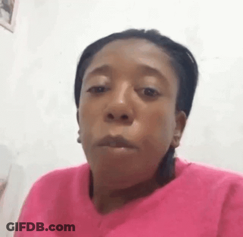 Woman In Pink Sweater Making Funny Face GIF