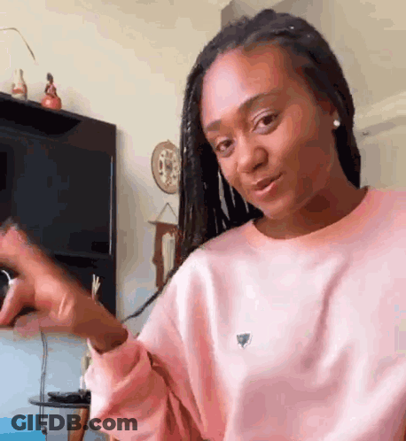 Woman In Pink Sweater Making Funny Face GIF