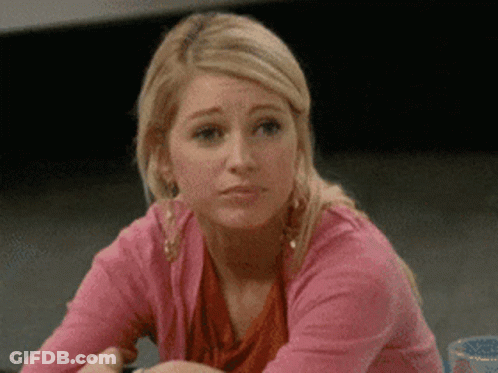 Woman In Pink Sweater Making Sad Face GIF