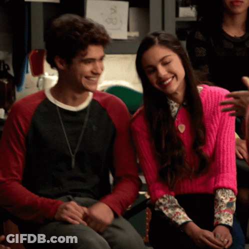 Woman In Pink Sweater Next To Man In Black Shirt GIF