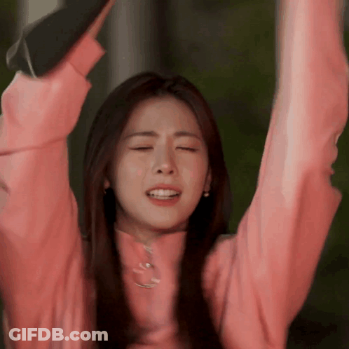 Woman In Pink Sweater Raising Arms GIF
