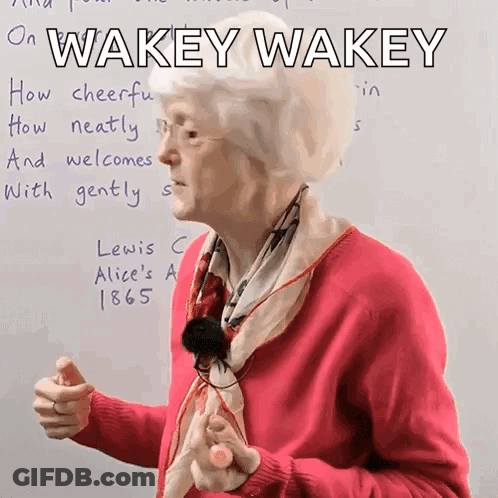 Woman In Pink Sweater Saying Wakey Wakey GIF