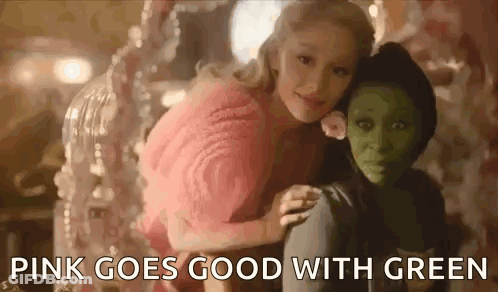 Woman In Pink Sweater Sitting Next To Green Girl GIF