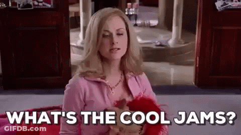 Woman In Pink Sweater Sitting On Bed Talking GIF