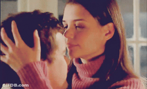 Woman In Pink Sweater Touching Man's Face GIF