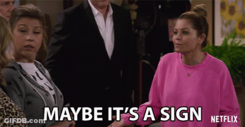 Woman In Pink Sweatshirt Saying Maybe It's A Sign GIF