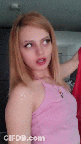 Woman In Pink Tank Top Holding Red Shirt GIF