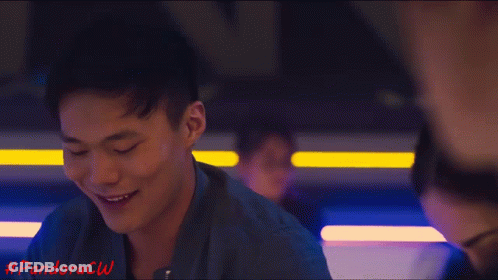 Woman In Pink Tank Top Sitting Next To Man GIF