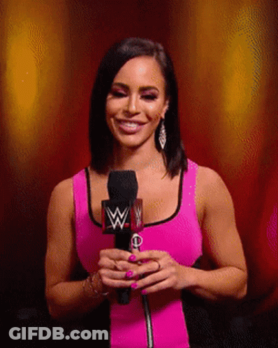 Woman In Pink Tank Top Smiling Holding Microphone W GIF