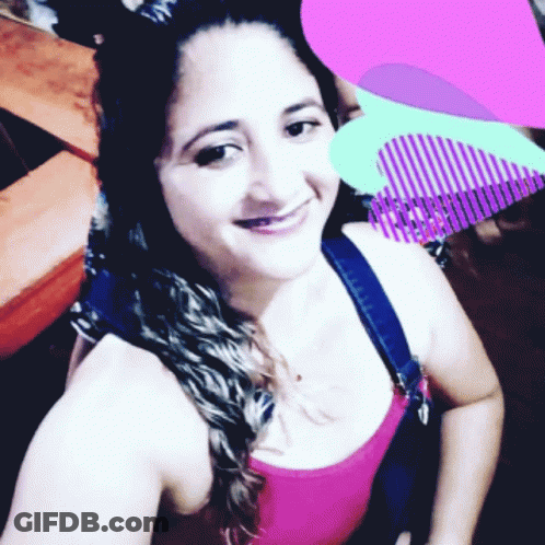 Woman In Pink Tank Top Smiling With Purple Heart GIF